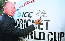NZ Prime Minister John Key signs a giant cricket ball at an event celebrating one year to go for the World Cup