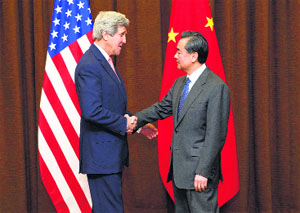 US Secretary of State John Kerry with Chinese Foreign Minister Wang Yi in Beijing on Friday. 