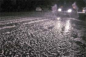 A car makes its way through a sudden and heavy hailstorm in Dehradun on Saturday