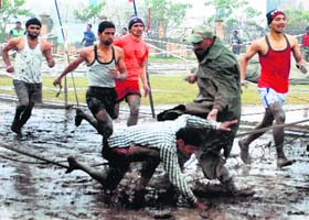 A youth falls while taking part in a race during an Army recruitment rally in Ambala on Saturday
