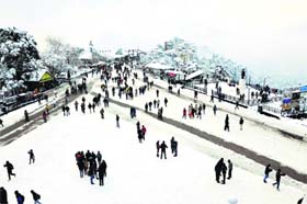 Tourists at The Ridge after a heavy snowfall in Shimla on Saturday