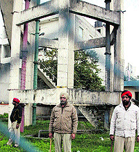 Policemen guard a water tank near the Jalandhar bus stand to check teachers union members from climbing the tank