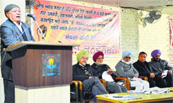 Communist leader Om Parkash addresses the gathering during a convention of the Centre of Indian Trade Union at Punjabi Bhawan in Ludhiana on Saturday. Photo: Inderjeet Verma