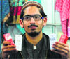 Muhammad Hussain shows bottles of ittar at the Indo-Pak expo in Ludhiana on Saturday. Tribune Photo: Himanshu Mahajan