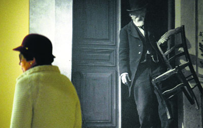 A woman walks past a picture of French artist Paul Cezanne during the presentation to the press of the exhibition dubbed “Cezanne Site/Non-Site” at the Thyssen-Bornemisza museum in Madrid.