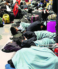 Stranded passengers at Haneda airport in Tokyo on Saturday