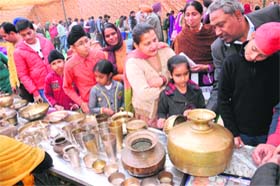Visitors have a look at the traditional utensils on the last day of the Virasat Mela in Bathinda on Sunday