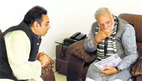 BJP prime ministerial candidate Narendra Modi talks to local party unit president Sanjay Tandon at the Chandigarh airport on Sunday.