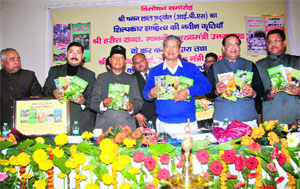 Chief Minister Harish Rawat releases books written by former Uttar Pradesh DGP Chaman Lal Pradhyot at a function 