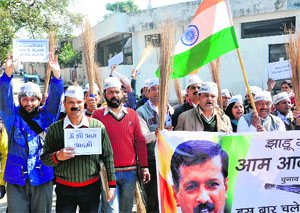 Aam Aadmi Party workers hold a Jhadu yatara at Nalapani Chowk in Dehradun on Sunday