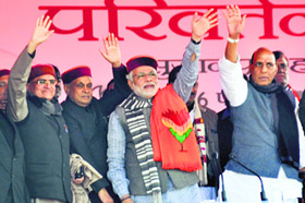 BJP prime ministerial candidate Narendra Modi flanked by party president Rajnath Singh (R), former HP Chief Minister Prem Kumar Dhumal (2L) and party leader Balbir Punj at a rally in Hamirpur district on Sunday. 