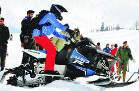 Chief Minister Omar Abdullah rides a snow scooter after the inauguration of National Ski and Snowboarding Championship in Gulmarg on Sunday.