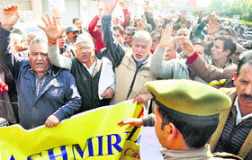 Members of the Prem Nath Bhat Memorial Trust protest outside the Press Club in Jammu on Sunday.