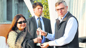 Chief Minister Omar Abdullah gives a prize to the winners of a golf tournament in Jammu.