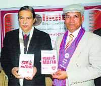 Vijay Sehgal and Dr Raj Rup Fuliya releasing Heart Mafia