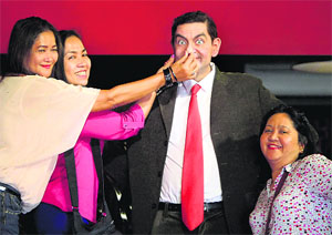 Tourists pose for photos with a wax figure of Mr Bean character at the Red Carpet Wax Museum at Shah Alam, outside Kuala Lumpur, on Sunday
