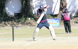 A batsman plays a shot during a match of the Girish Bhadri Memorial Cricket Tournament in Dehradun on Monday.