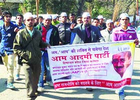 Aam Aadmi Party members take out a "jharu yatra" at Dehra in Kangra on Monday