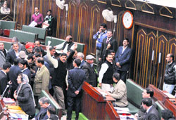 Opposition MLAs walk out of the Assembly protesting shortage of ration on Monday. Tribune photo