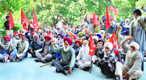 Members of Kirti Kisan Union hold a protest outside the DCs office in Ludhiana on Monday.