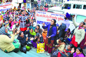 Members of the Contract Multipurpose Health Workers Union sit on a strike in Ludhiana on Monday.