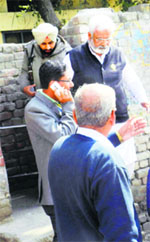 Health Minister Surjit Jyani being escorted out of a hospital in Moga on Monday.