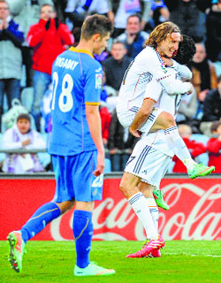 Real Madrids Luka Modric (centre) celebrates after scoring against Getafe in their La Liga match on Sunday.