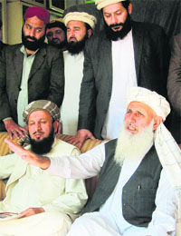 Pakistan Taliban members, part of the committee nominated to take part in peace talks with the Pakistan Government, speak to the media in Akora Khattak on Monday.