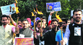 BJP members hold placards in support of Narendra Modi during an event organised to launch Jago Yatra-2014 at Sector 27 in Chandigarh on Tuesday.