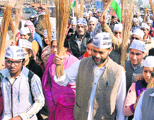 Yogendra Yadav and other activists of the Aam Aadmi Party take part in a 'jharoo sandesh yatra' in Gurgaon on Tuesday.