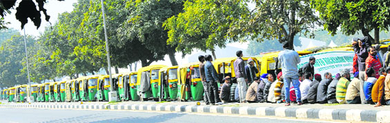 LPG auto-rickshaws queued up on the road separating sectors 33 and 34 in Chandigarh as operators went on strike on Wednesday. Tribune photo: S Chandan