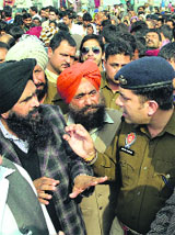 ADCP-IV Swapan Sharma tries to pacify protesters who blocked traffic jam on the national highway in Ludhiana on Tuesday.