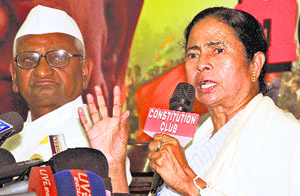 TMC chief Mamata Banerjee at a press conference in Delhi on Wednesday as Anna Hazare looks on.
