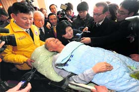 Waiting for the reunion: Kim Sun-kyum, 91, is helped by a Red Cross official as he arrives to take part in family reunions with his North Korean family members at a hotel in Sokcho, South Korea, on Wednesday