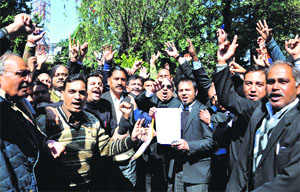 Lawyers demonstrate outside the DM office in Dehradun on Thursday.