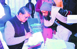 Chief Minister Harish Rawat gives a patient hearing to the issues of the people at the Bijapur guest house in Dehradun on Thursday. 