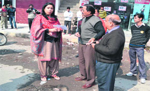 District Magistrate Nidhi Pandey directs department officials to repair pot-holed roads among other civic issues, during an impromptu inspection of roads in Haridwar on Thursday.