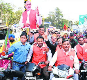 BJP MLA Manoranjan Kalia takes part in a scooter rally in Jalandhar on Thursday.