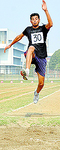 A student performs long jump on the opening day of the annual athletics meet of PAU, Ludhiana, on Thursday
