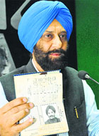 PPCC general secretary Rajanbir Singh shows his fathers passport in Chandigarh on Thursday.