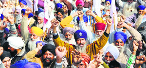 Farmers protest outside the PSPCL office in Amritsar on Thursday.
