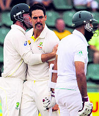 Mitchell Johnson is all pumped up after he dismisses Hashim Amla on the first day of the second Test on Thursday