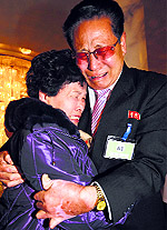 Emotional reunion: North Korean Lee Yun-geun hugs his South Korean sister Lee Sun-hyang during their family reunion at the Mount Kumgang resort in North Korea on Thursday