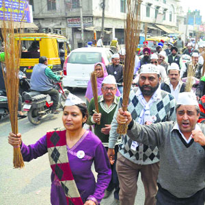 AAP activists participate in 'Jharu Chalao Yatra' campaign in Amritsar on Friday.