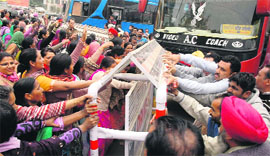 ASHA workers clash with private bus operators during a protest outside the bus stand in Bathinda on Friday.