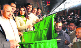 Mayor HC Kalyan (left) flags off the Kerala Sampark Kranti Express from the Chandigarh railway station on Friday.