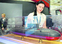 A visitor looks at a model of a Submarine during Defexpo India in New Delhi. 