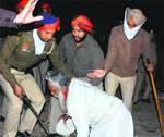 A farmer falls to the ground during a police lathi charge in Amritsar. photo: Vishal Kumar