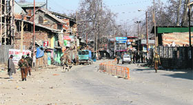 Security forces personnel patrol Pulwama town.