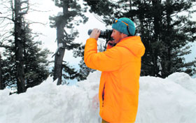A foreign tourist captures the beauty of nature at Tangmarg in Baramulla district on Friday.